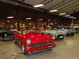 A garage with several vintage cars at a fundraiser for Heartlight Ministries.